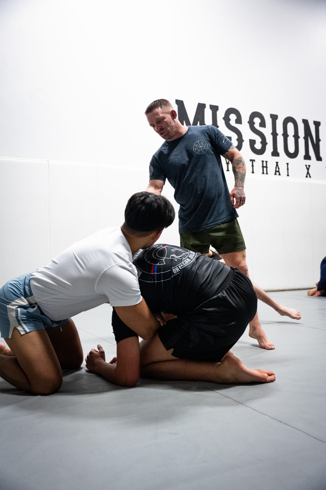 Coach guiding a one-on-one grappling session during private training at Mission BJJ in Mission, BC