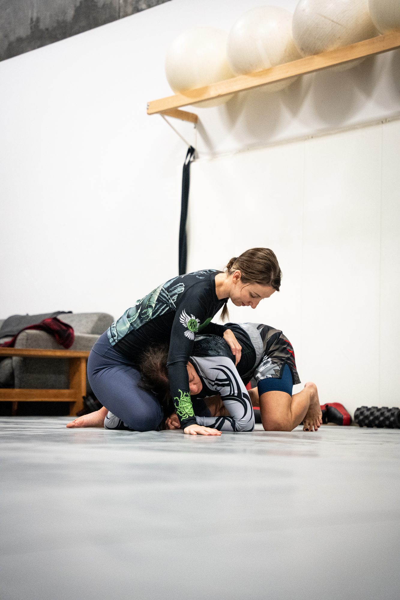 Partners drilling a self defence ground control technique on the mats at Mission BJJ in Mission, BC